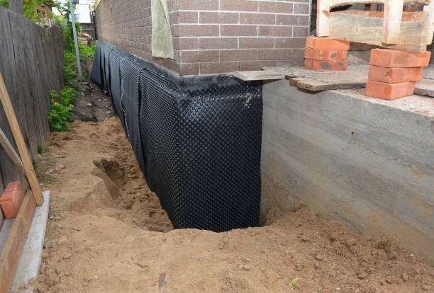 Happy homeowners after waterproofing job in Holt